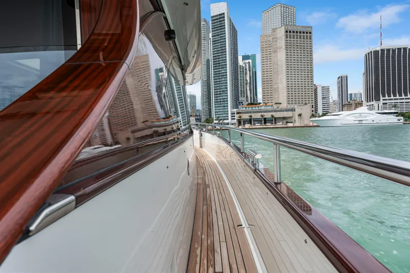 Tribu Yacht Photos Pics Steeler 60 S Performance yacht, 2021, cruising near city skyline and waterfront buildings.