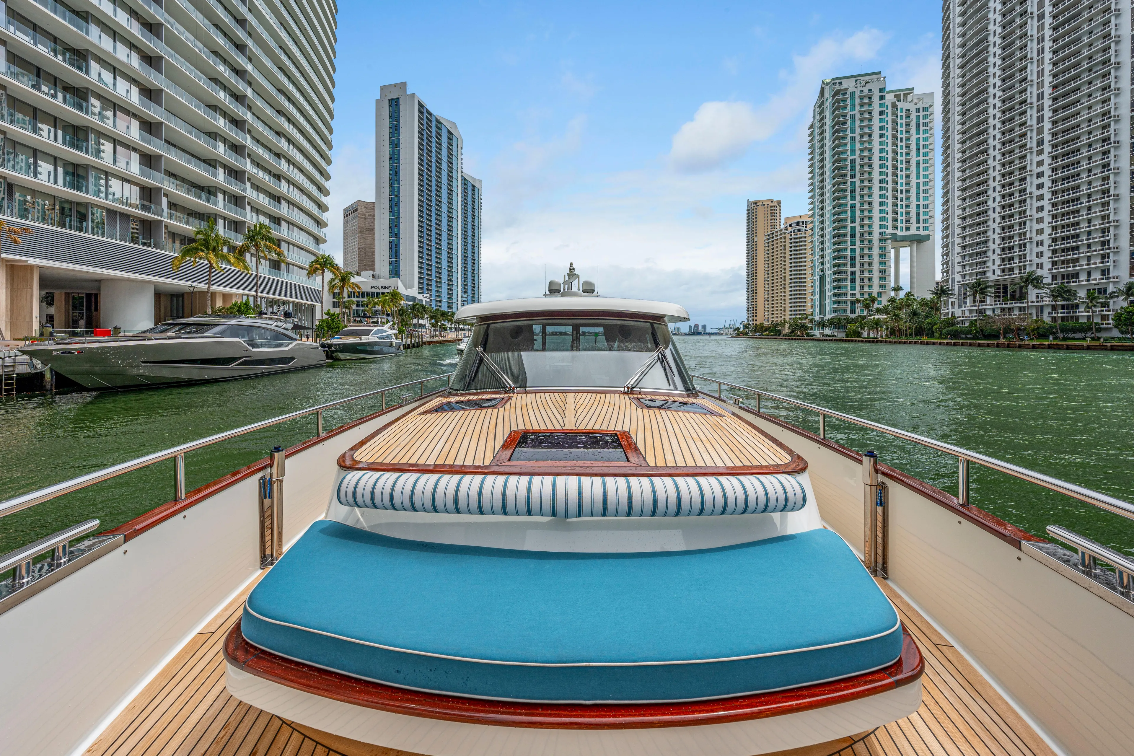 Tribu Yacht Photos Pics 2021 Steeler 60 S Performance yacht cruising in urban waterway with skyscrapers.