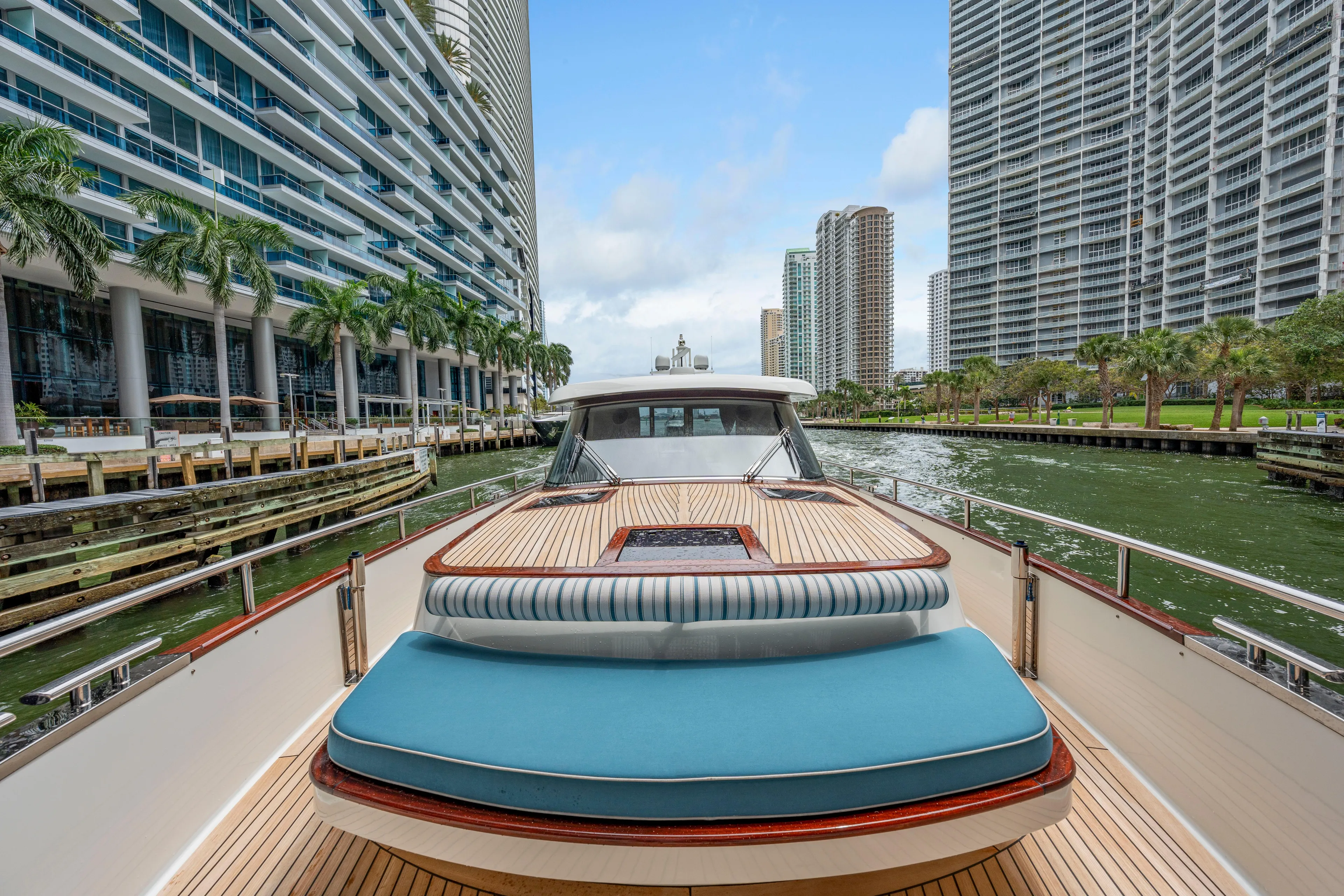 Tribu Yacht Photos Pics 2021 Steeler 60 S Performance yacht cruising in urban waterway with skyscrapers.