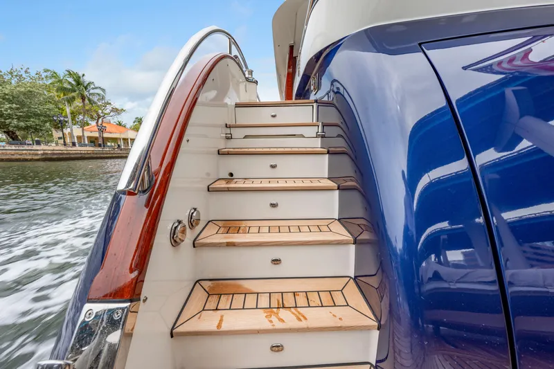Tribu Yacht Photos Pics Staircase on a 2021 Steeler 60 S Performance yacht, featuring sleek design and wooden steps.