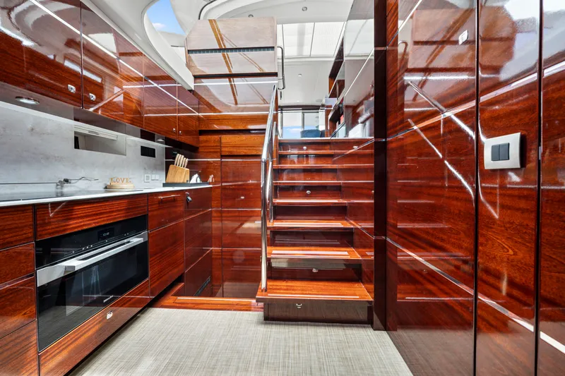 Tribu Yacht Photos Pics Luxurious interior of 2021 Steeler 60 S Performance yacht with polished wood finish.