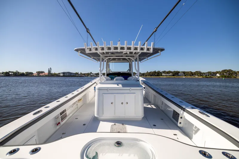  Yacht Photos Pics 2024 Yellowfin 39 Offshore boat on calm water, showcasing spacious deck and sleek design.