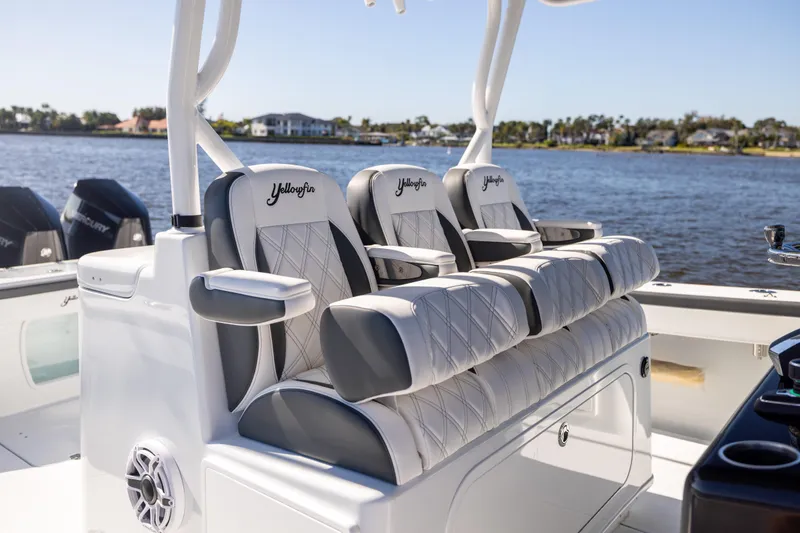  Yacht Photos Pics 2024 Yellowfin 39 Offshore boat with luxurious seating, on a scenic waterfront.