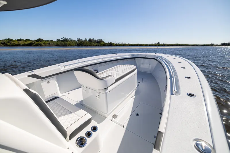  Yacht Photos Pics 2024 Yellowfin 39 Offshore boat interior, featuring sleek seating and spacious deck on calm waters.