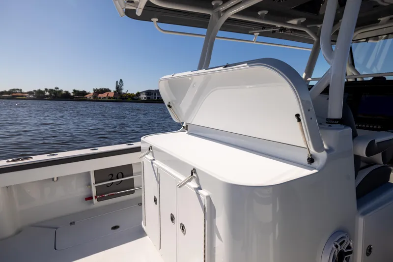  Yacht Photos Pics 2024 Yellowfin 39 Offshore boat interior with open storage compartment, overlooking calm waters.