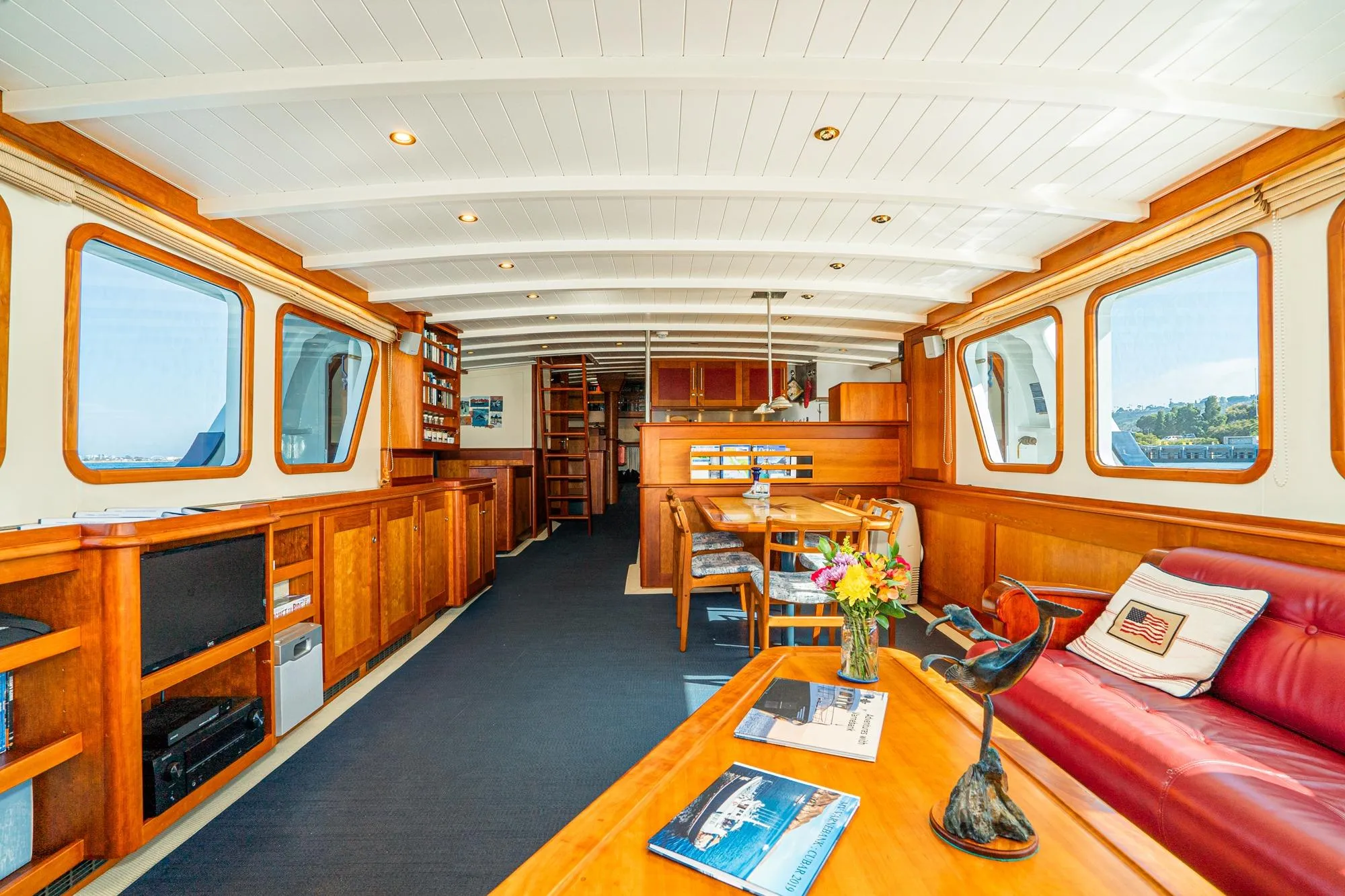 Luxurious 1965 Van der Molen Custom yacht interior with elegant wood finishes and comfortable seating.