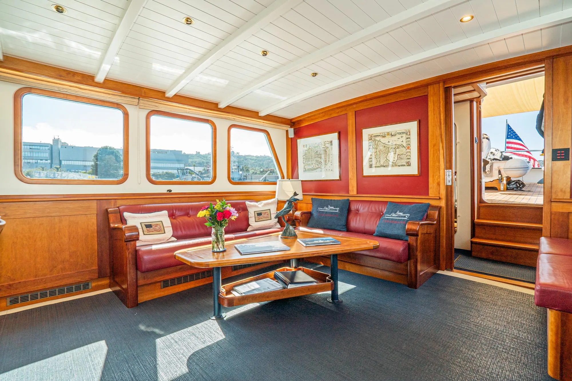 Luxurious 1965 Van der Molen yacht interior with elegant wood paneling and plush seating.