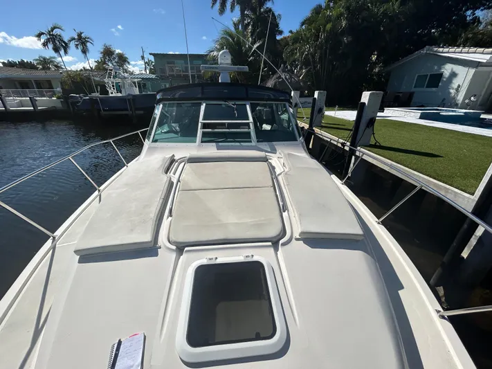 Reel Estate Yacht Photos Pics 1998 Tiara Yachts 3500 Express docked, showcasing spacious deck and sleek design.