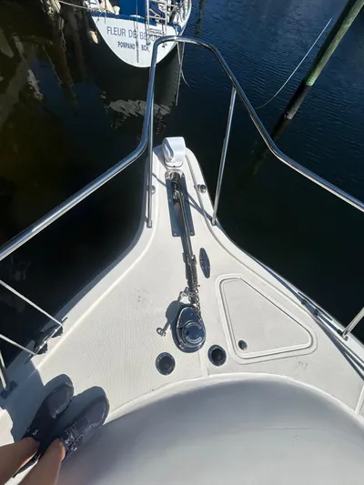 Reel Estate Yacht Photos Pics Bow of 1998 Tiara Yachts 3500 Express, docked, with visible anchor and railing.