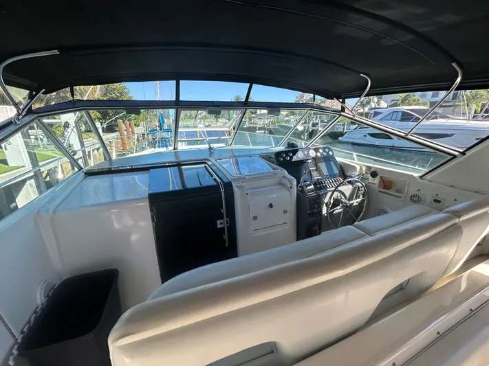 Reel Estate Yacht Photos Pics 1998 Tiara Yachts 3500 Express cockpit with helm, seating, and navigation equipment.