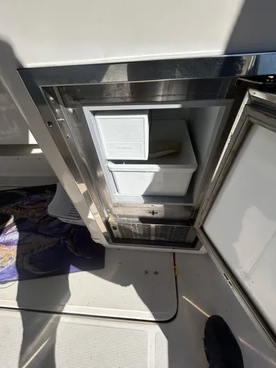 Reel Estate Yacht Photos Pics 1998 Tiara Yachts 3500 Express, open mini fridge on deck, stainless steel finish.
