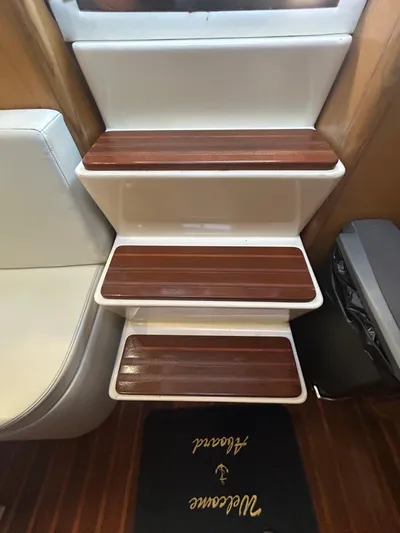 Reel Estate Yacht Photos Pics Staircase inside 1998 Tiara Yachts 3500 Express with wooden steps and welcome mat.