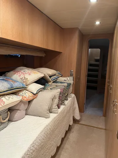  Yacht Photos Pics Interior of 2007 PerMare Amer 86 yacht with cozy cabin and decorative pillows.