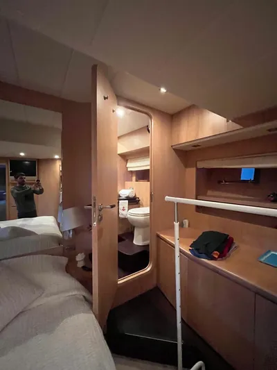  Yacht Photos Pics Luxurious cabin interior of 2007 PerMare Amer 86 yacht, featuring wooden furnishings and ensuite bathroom.