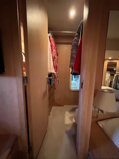  Yacht Photos Pics Wooden interior of 2007 PerMare Amer 86 yacht with closet and cozy bedroom.