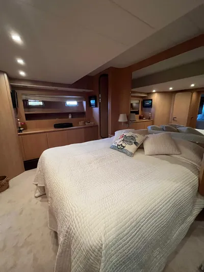  Yacht Photos Pics Luxurious bedroom interior of 2007 PerMare Amer 86 yacht with elegant bedding and wooden accents.