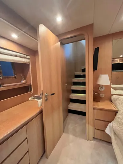  Yacht Photos Pics Interior of 2007 PerMare Amer 86 yacht, featuring wooden cabinetry and stairs.