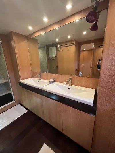  Yacht Photos Pics Luxurious bathroom in 2007 PerMare Amer 86 yacht with dual sinks and wooden cabinetry.