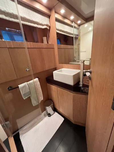  Yacht Photos Pics Luxurious bathroom in 2007 PerMare Amer 86 yacht with modern fixtures and wooden cabinetry.