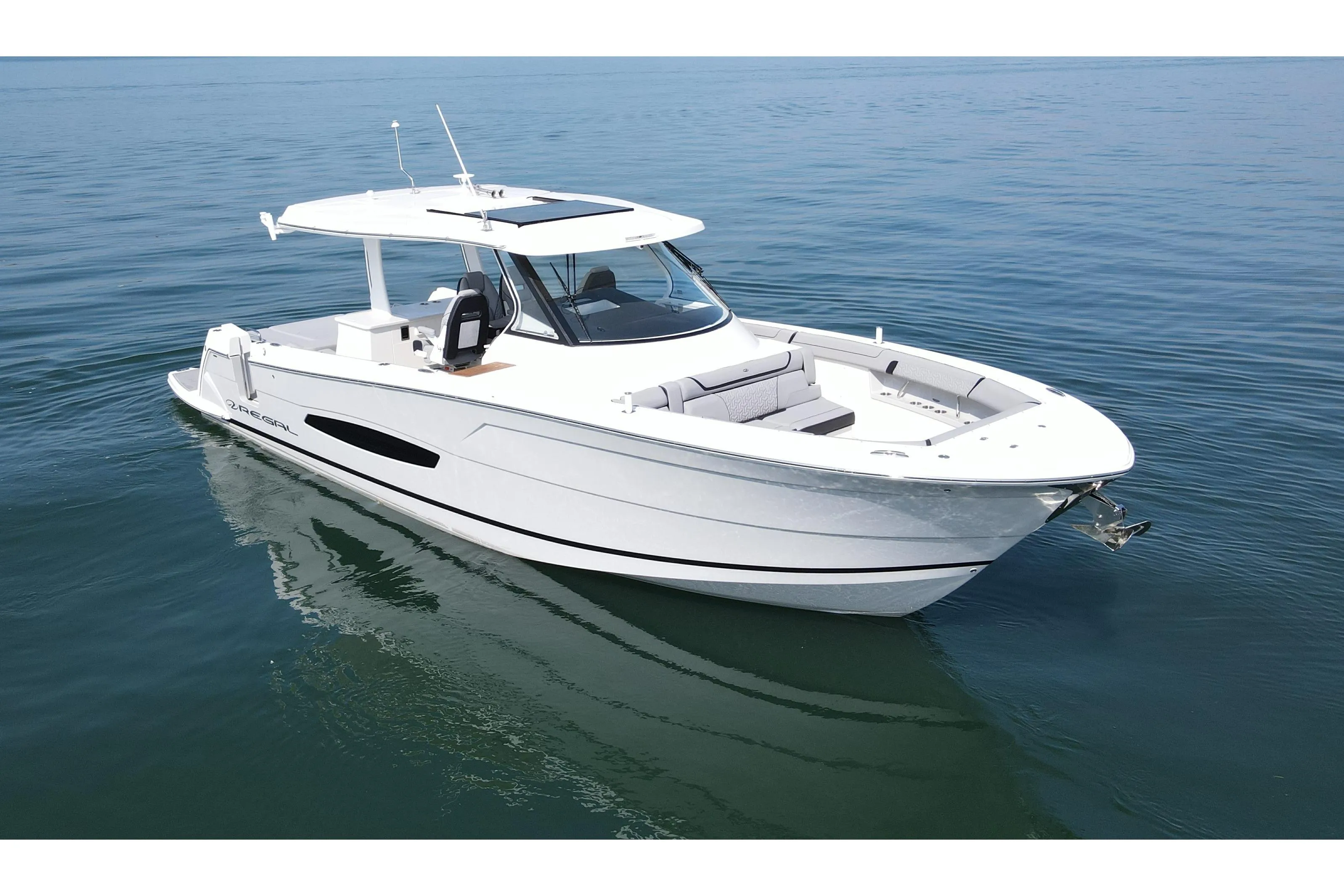 2024 Regal 38 Surf boat on calm water, showcasing sleek design and luxury features.