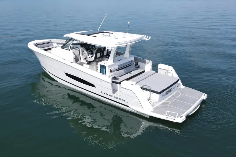 It's Good Yacht Photos Pics 2024 Regal 38 Surf boat on calm water, showcasing sleek design and spacious deck.