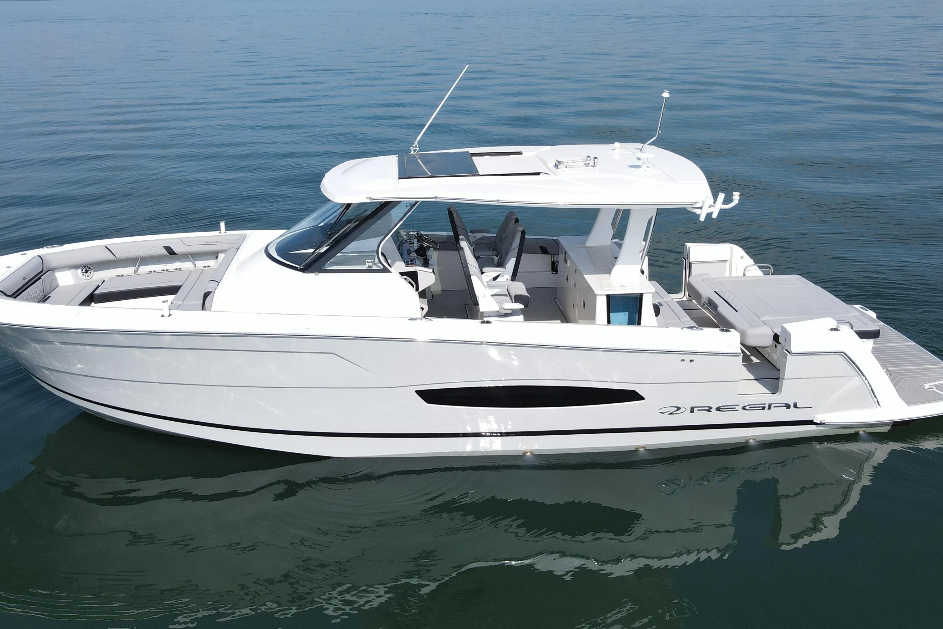 2024 Regal 38 Surf boat on calm water, showcasing sleek design and modern features.