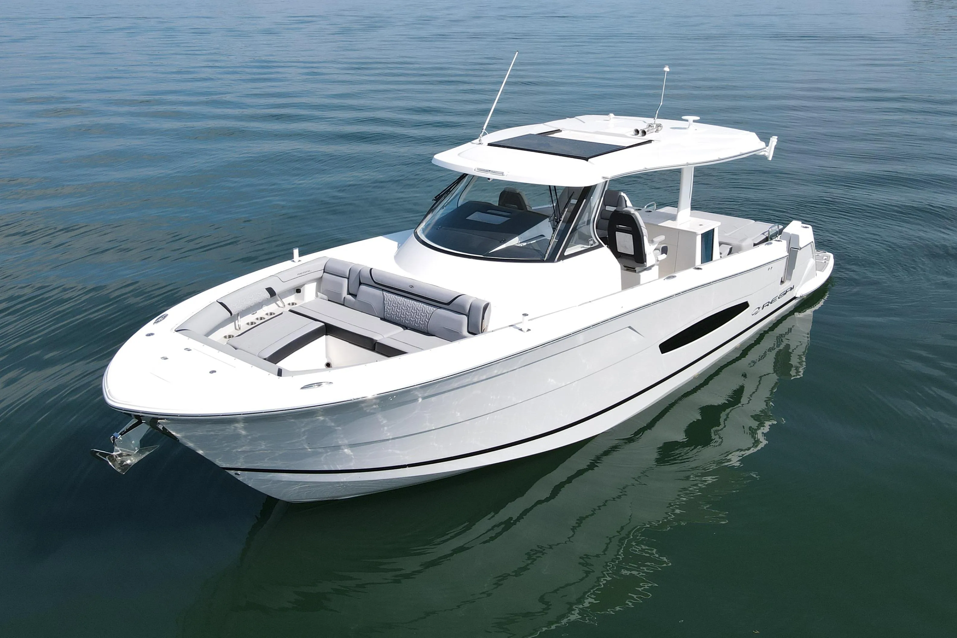 2024 Regal 38 Surf boat on calm water, showcasing sleek design and modern features.