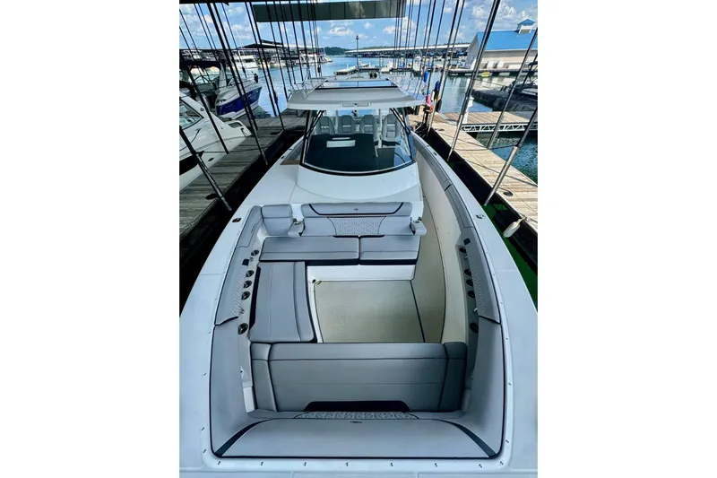 It's Good Yacht Photos Pics 2024 Regal 38 Surf boat with spacious seating at a marina dock.