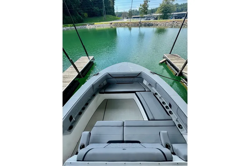 It's Good Yacht Photos Pics 2024 Regal 38 Surf boat interior with luxurious seating at a serene dock.