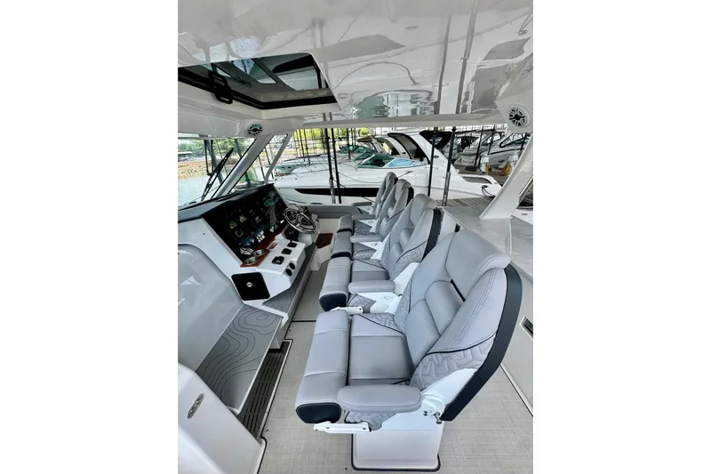 It's Good Yacht Photos Pics 2024 Regal 38 Surf boat interior with modern seating and control panel.