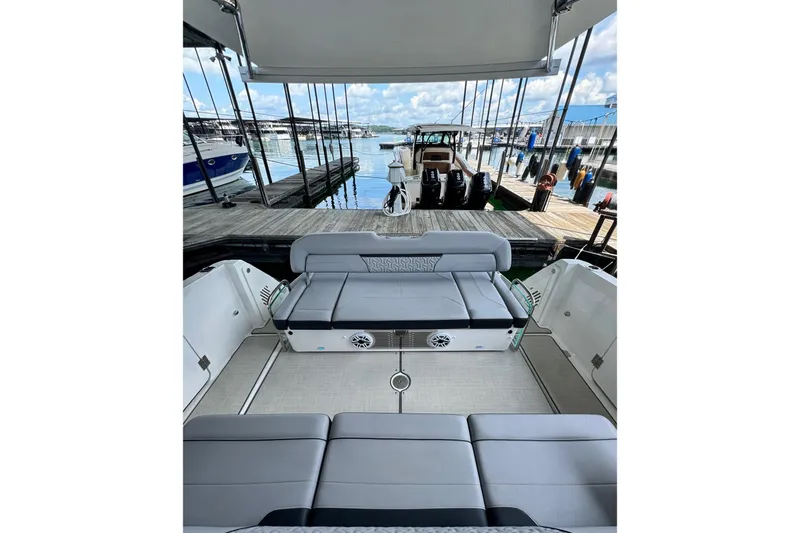 It's Good Yacht Photos Pics 2024 Regal 38 Surf boat interior with gray seating, docked at marina.