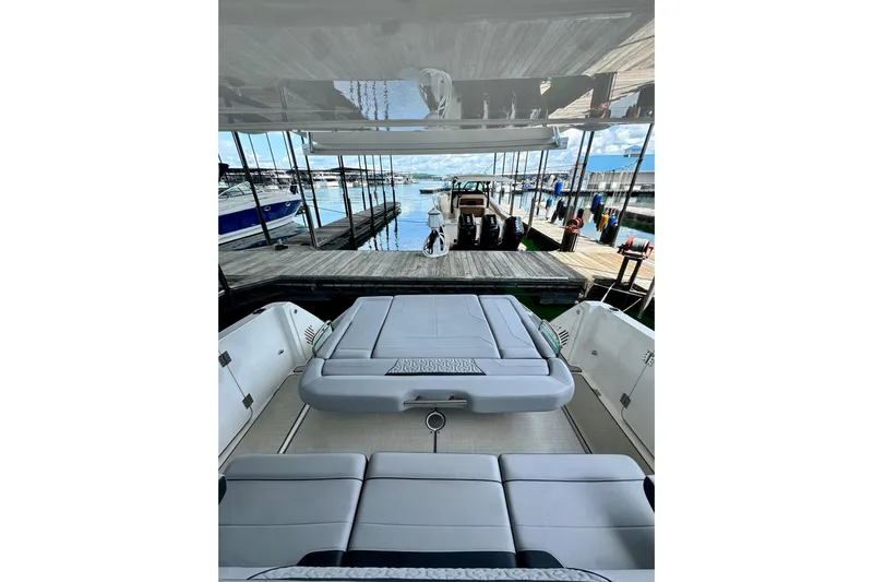 It's Good Yacht Photos Pics 2024 Regal 38 Surf boat interior with luxurious seating at a marina.