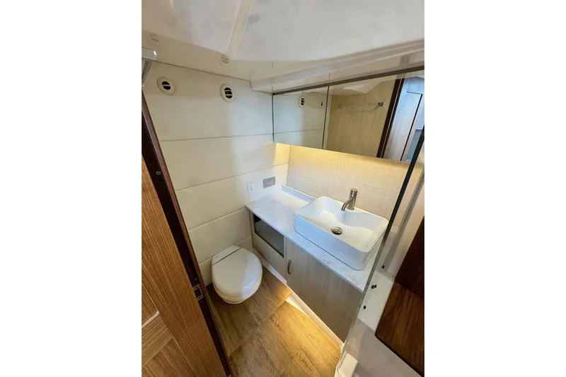 It's Good Yacht Photos Pics Luxurious bathroom in 2024 Regal 38 Surf yacht with modern sink and toilet.