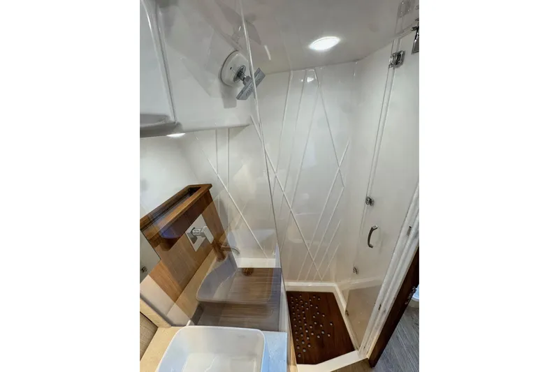 It's Good Yacht Photos Pics 2024 Regal 38 Surf bathroom with modern shower and wooden accents.