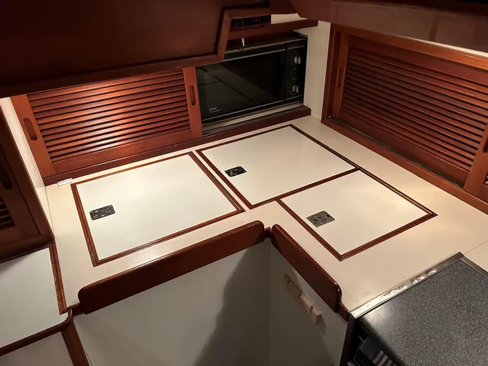 Helianthus Yacht Photos Pics 1985 Hinckley SW 42 yacht interior with wooden cabinetry and sleek countertops.