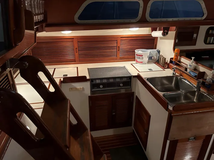Helianthus Yacht Photos Pics 1985 Hinckley SW 42 yacht kitchen with wooden cabinetry and dual sinks.