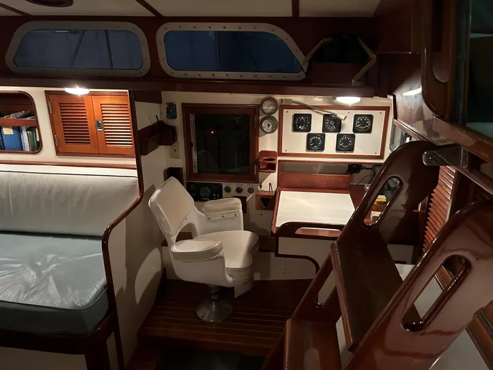 Helianthus Yacht Photos Pics Interior of 1985 Hinckley SW 42 sailboat with wooden accents and seating area.