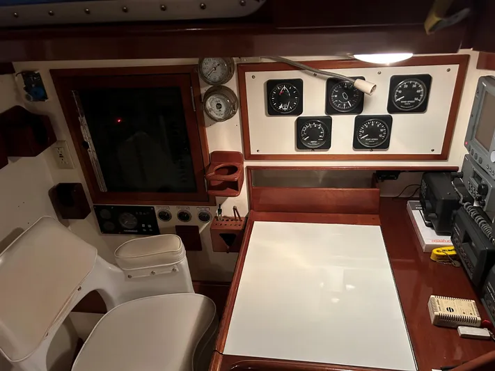 Helianthus Yacht Photos Pics Navigation station of 1985 Hinckley SW 42 yacht with instruments and seating.