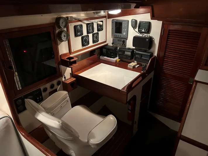 Helianthus Yacht Photos Pics 1985 Hinckley SW 42 yacht interior with navigation equipment and captain's chair.