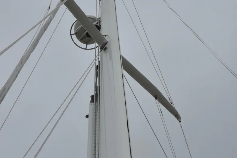 Helianthus Yacht Photos Pics Mast and rigging of a 1985 Hinckley SW 42 sailboat against a cloudy sky.