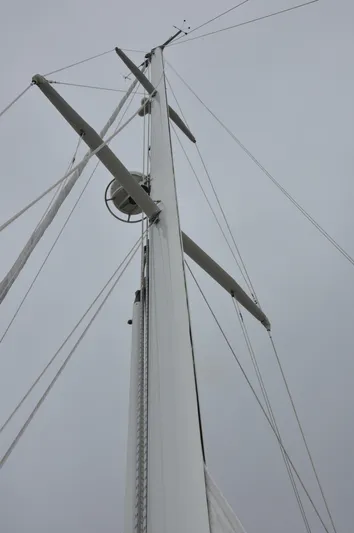 Helianthus Yacht Photos Pics Mast of 1985 Hinckley SW 42 sailboat against cloudy sky.