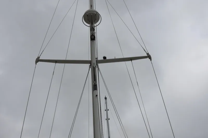 Helianthus Yacht Photos Pics Mast of 1985 Hinckley SW 42 sailboat against cloudy sky.