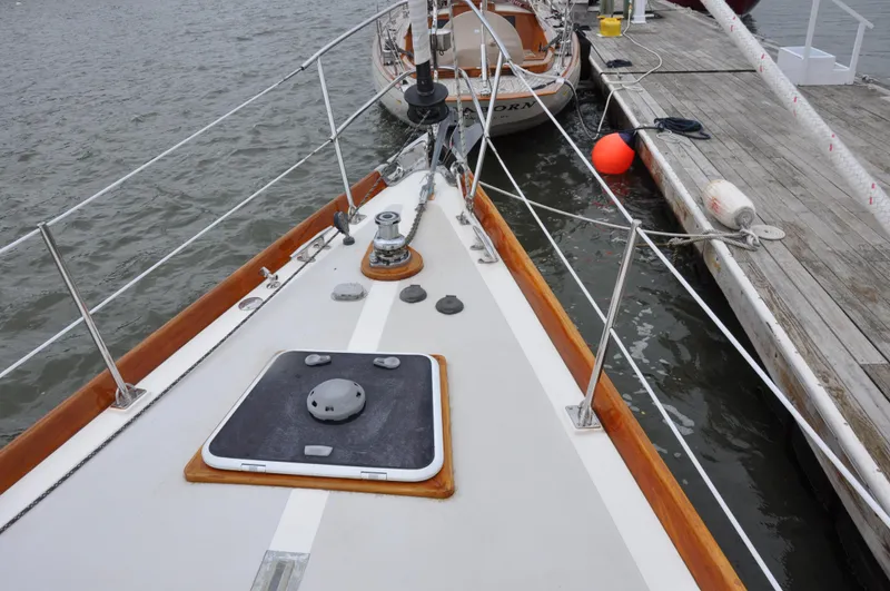 Helianthus Yacht Photos Pics Hinckley SW 42 sailboat bow, docked, 1985 model, wooden trim, deck hatch, and mooring lines.
