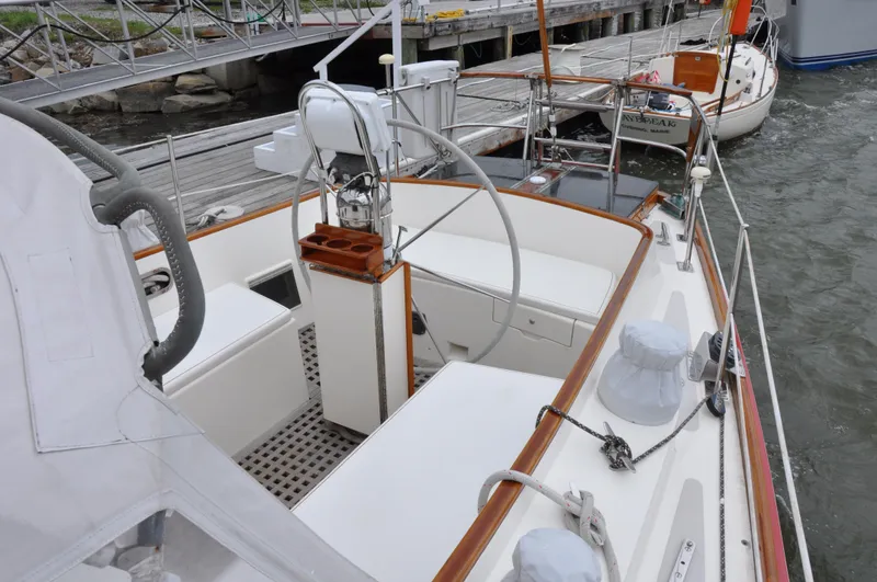 Helianthus Yacht Photos Pics 1985 Hinckley SW 42 sailboat cockpit with steering wheel and docked at marina.