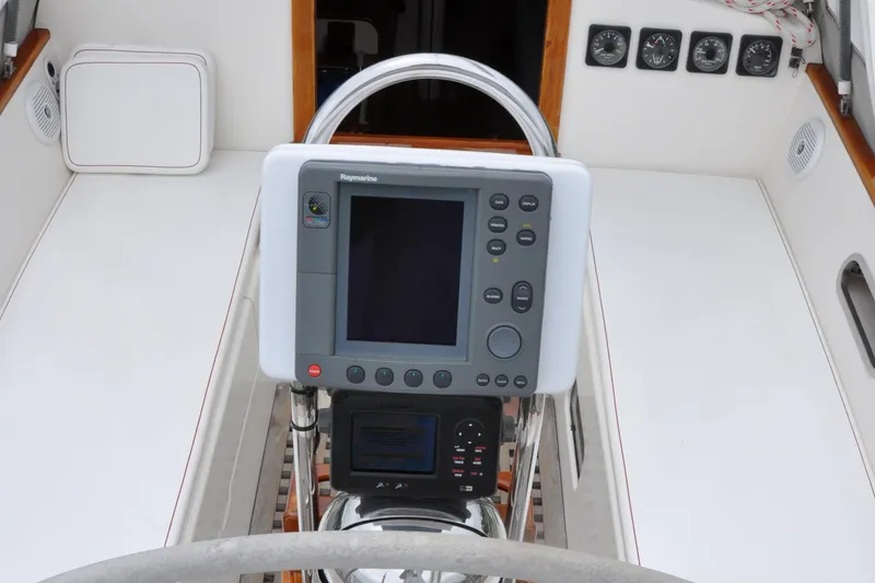 Helianthus Yacht Photos Pics Hinckley SW 42 1985 sailboat cockpit with navigation equipment and steering wheel.