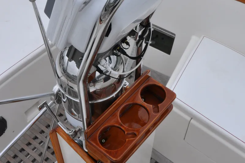 Helianthus Yacht Photos Pics Hinckley SW 42 1985 yacht helm with wooden cup holders and stainless steel details.