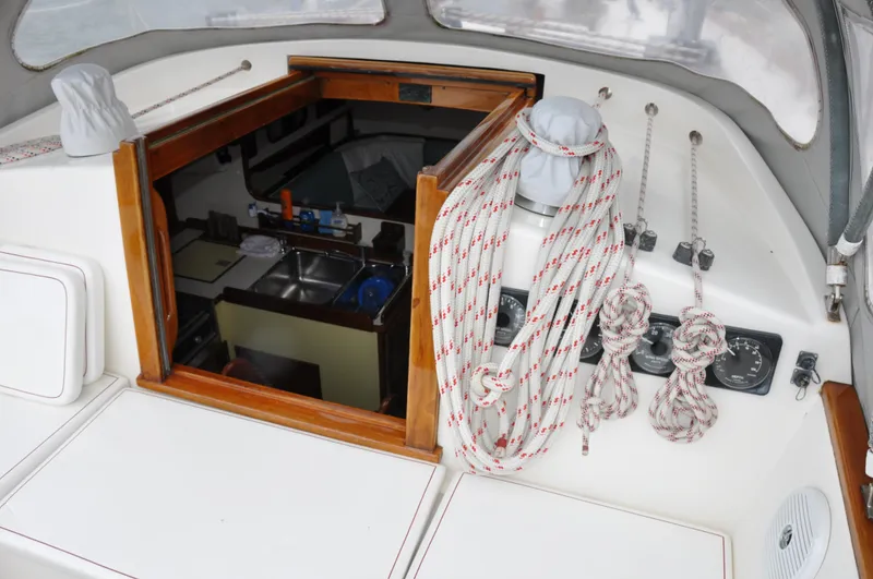 Helianthus Yacht Photos Pics 1985 Hinckley SW 42 sailboat cockpit with view into cabin and rigging ropes.