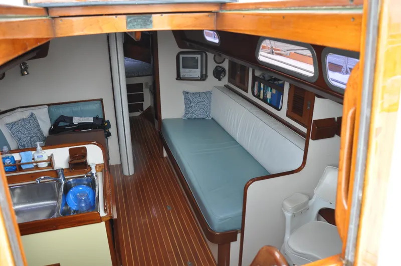Helianthus Yacht Photos Pics Interior of 1985 Hinckley SW 42 sailboat with seating, kitchen, and sleeping area.