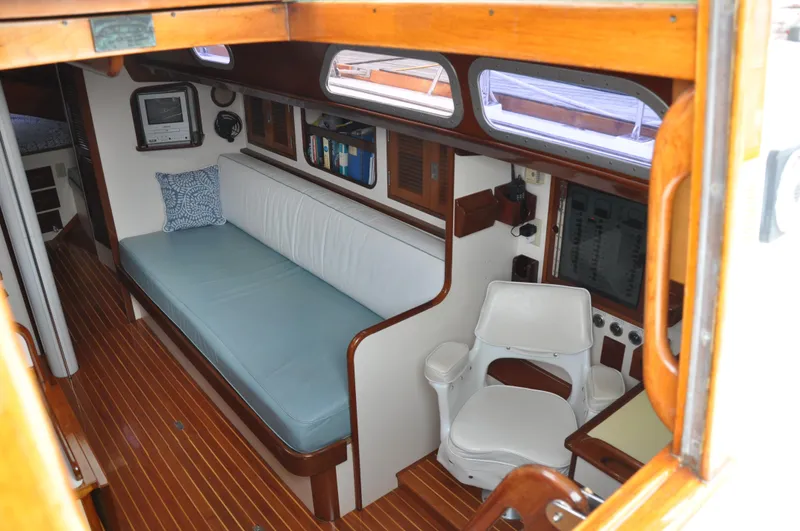 Helianthus Yacht Photos Pics Interior of 1985 Hinckley SW 42 sailboat with wooden flooring and seating area.