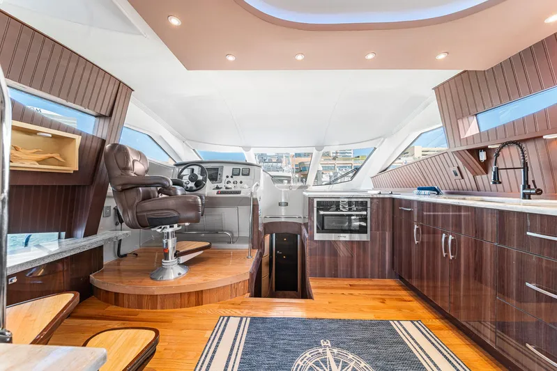 Sunline Yacht Photos Pics Luxurious interior of 2007 Marquis 55 LS yacht with modern kitchen and captain's chair.